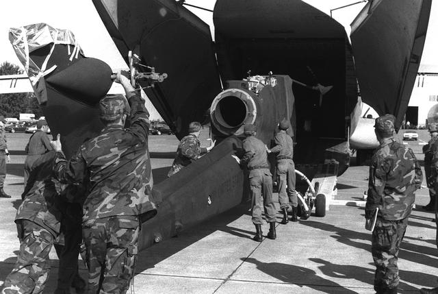 Image: AH-1 Cobra helicopter being loaded into a C-141 Starlifter