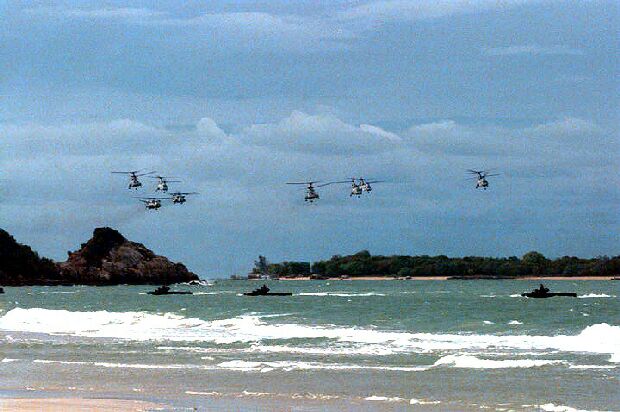 Image: CH-46 Sea Knight and CH-53 Super Stallion helicopters attack from the sea.