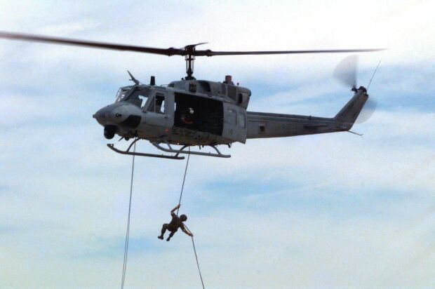 Image: Marines practice repelling from a UH-1 Huey helicopter at Twentynine Palms, Calif.