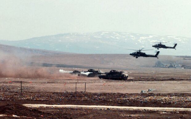 Image:M1-A1 Abrams tanks and AH-64A Apache helicopters fire at a range in Bosnia and Herzegovina.