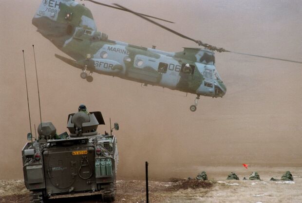 Image: A U.S. Marine CH-46 Sea Knight lifts off after unloading Marines at Glamoc.