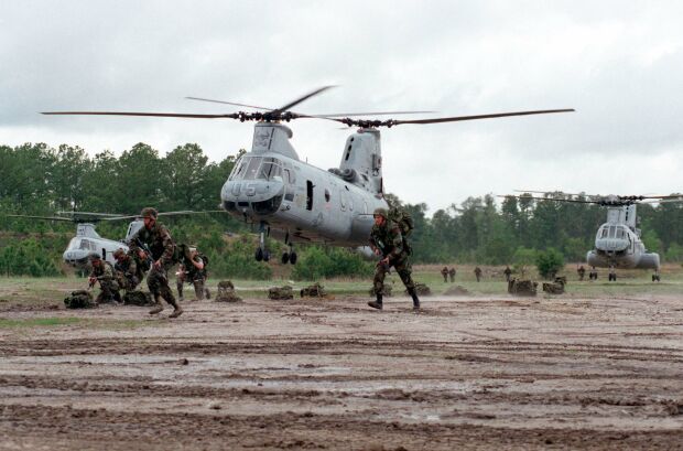 Image: U.S. Marines move away from CH-46 Sea Knight helicopters at Landing Zone Coot.