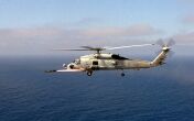 Image: An AGM-114B Hellfire missile roars off the rails of a SH-60 Helicopter.