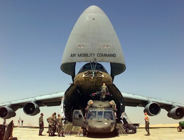 Image: U.S. Army personnel unload their UH-60L Black Hawk helicopters from a U.S. Air Force C-5 Galaxy at Cairo West.